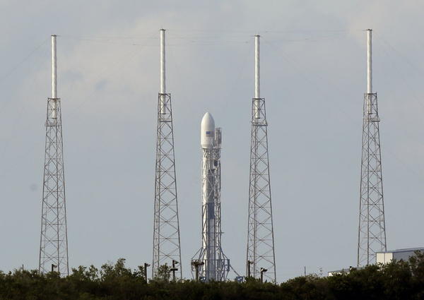 A SpaceX Falcon 9 rocket carrying a payload of Orbcomm communications satellites is seen at launch complex 40 after an attempted launch was scrubbed due to technical issues at the Cape Canaveral Air Force Station in Cape Canaveral, Fla.