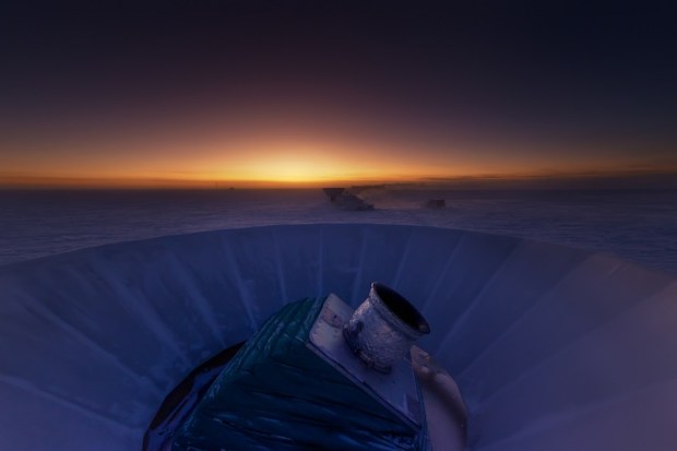 The BICEP2 telescope at twilight, which occurs only twice a year at the South Pole. The MAPO observatory (home of the Keck Array telescope) and the South Pole station can be seen in the background.
