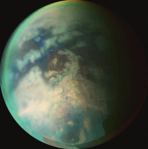 This image is a composite of several images taken during two separate Titan flybys in 2006. The large circular feature near the center of Titan’s disk may be the remnant of a very old impact basin. The mountain ranges to the southeast of the circular feature, and the long dark, linear feature to the northwest of the old impact scar may have resulted from tectonic activity on Titan caused by the energy released when the impact occurred. Image credit: NASA/JPL/University of Arizona.