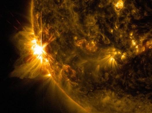 This image from NASA’s Solar Dynamic Observatory captures the first of three giant flares erupting from the sun’s surface on June 10, 2014. Credit: NASA/SDO/Goddard/Wiessinger
