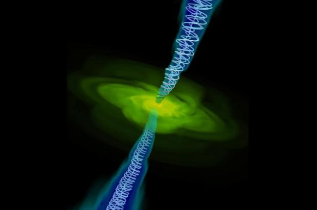 This is a computer simulation of gas (in yellow) falling into a black hole (too small to be seen). Twin jets are also shown with magnetic field lines. Credit: Alexander Tchekhovskoy, Berkeley Lab