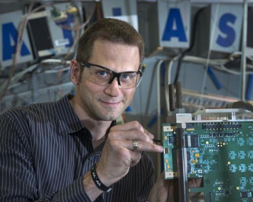 Brookhaven Lab/ATLAS physicist Marc-André Pleier adjusting detector components. (Credit: Brookhaven Lab/ATLAS)
