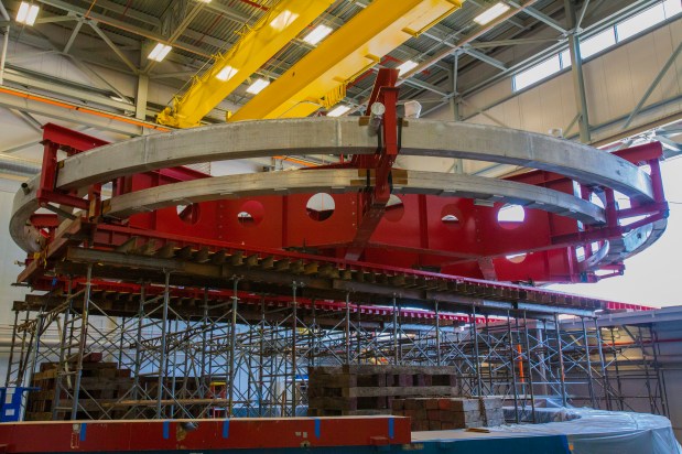 The 50-foot-wide Muon g-2 electromagnet at rest inside the Fermilab building that will house the experiment. The magnet was moved into the new building on Wednesday, July 30, 2014. The magnet will allow scientists to precisely probe the properties of subatomic particles called muons. (Credit: Fermilab.)