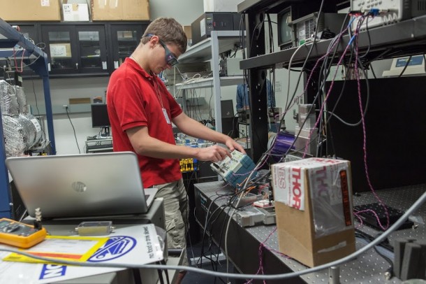 NASA Goddard intern Robert Buttles adjusts equipment used for the eLISA mission, which will test for vibrations that could reveal subtle changes in gravity. Image (Credit: NASA Goddard/Kristen Basham)