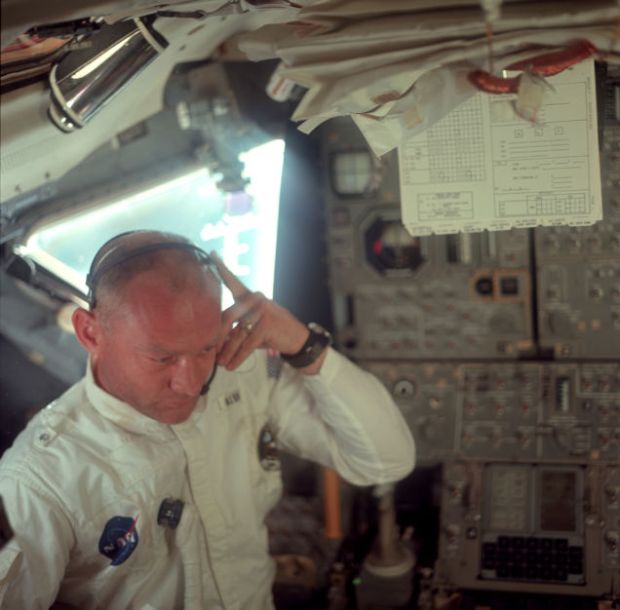 Buzz Aldrin listening to mission control transmission during translunar coast NASA/Project Apollo Archive