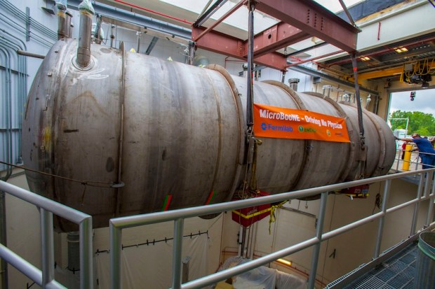 The detector for the MicroBooNe is gently lowered into place. (Credit: Fermilab)