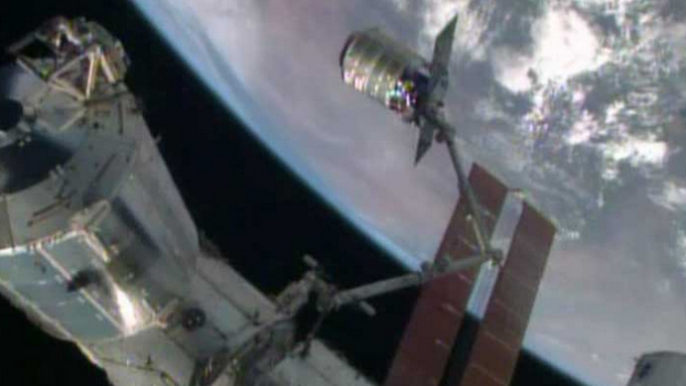 The International Space Station’s robotic arm, Canadarm2, grapples the Orbital Sciences’ Cygnus cargo craft. (Source: NASA TV) 