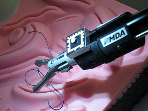 The suturing tool demonstrates image-guided anastomosis, which means the connecting of parts such as vessels. The target on the top of the tool is used to lead the tool's tip. This is the same technology used to track the robotic systems on the space shuttle and the International Space Station. (Credit: MDA and CIGITI)