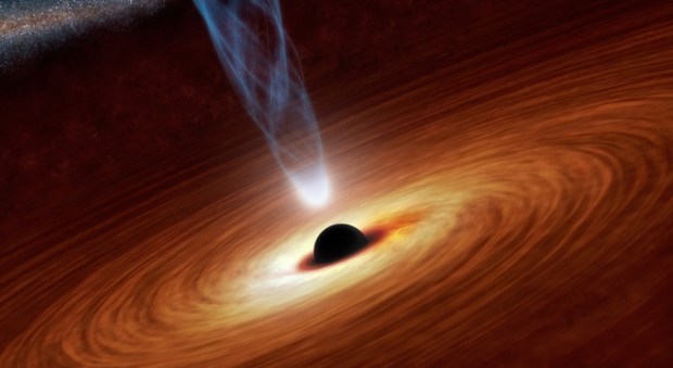 This artist’s concept illustrates a supermassive black hole with millions to billions times the mass of our sun. Supermassive black holes are enormously dense objects buried at the hearts of galaxies. (Credit: NASA/JPL-Caltech)