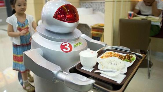  A robot carries food to customers in a restaurant in Kunshan, China. Photo: Johannes Eisele. (Credit: AFP)