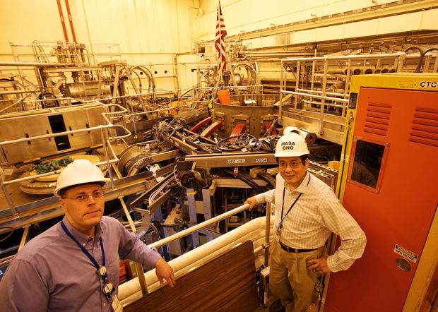 Jonathan Menard, a principal research physicist and program director for the National Spherical Torus Experiment (NSTX), and Masa Ono, a principal research physicist and project director of the NSTX, stand in front of the experiment during a tour of the facility. The device has been shut down since 2011 while it undergoes a $94 million upgrade that will make it the most powerful device of its kind in the world