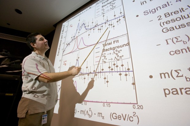 CDF physicist Petar Maksimovic, professor at Johns Hopkins University, presented the discovery to the particle physics community at Fermilab. He explained that the two types of Sigma-sub-b particles are produced in two different spin combinations, J=1/2 and J=3/2, representing a ground state and an excited state, as predicted by theory. (Credit: Fermilab)