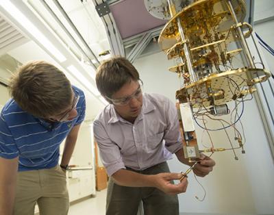  Kater Murch (right), assistant professor of physics at Washington University in St. Louis, and junior Chris Munley work with the equipment that can map a quantum device's trajectory between two points in quantum state space, a feat until recently considered impossible. (Credit: Joe Angeles/WUSTL Photos)