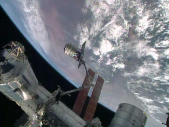 The International Space Station's robotic arm, Canadarm2, grapples the Orbital Sciences' Cygnus cargo craft, as seen in this still image taken from NASA TV July 16, 2014.  (Credit: Reuters/NASA TV/Handout via Reuters)