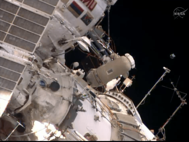 Cosmonaut Oleg Artemyev looks on after he released a small Peruvian satellite into space during a spacewalk outside the International Space Station on Aug. 18, 2014. (Credit: NASA TV)