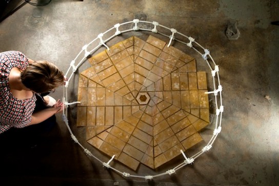Shannon Zirbel with the solar panel array prototype, designed using the principles of origami, unfolded (Credit: BYU, Meier)