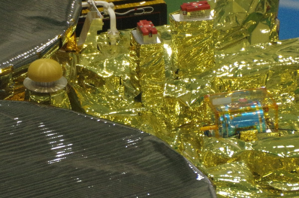 The little mushroom cap between the two high-gain antennas is the X-band low-gain antenna. The little blue thing is DCAM3, a deployable camera that will hopefully take pictures of the explosion and impact of Hayabusa's "Small Carry-on Impactor" while the mothership hides safely in the shadow of the asteroid.