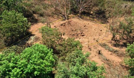 In this Sunday Sept. 7, 2014, publicly distributed handout photo provided by the Nicaraguan Army shows an impact crater made by a small meteorite in a wooded area near Managua's international airport and an air force base. Nicaraguan government spokeswoman Rosario Murillo said Sunday that a loud boom heard overnight by residents of the capital was a "relatively small" meteorite that "appears to have come off an asteroid that was passing close to Earth." (Credit: Nicaraguan Army/AP)