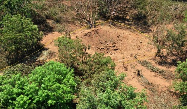 In this Sunday Sept. 7, 2014, publicly distributed handout photo provided by the Nicaraguan Army shows an impact crater made by a small meteorite in a wooded area near Managua's international airport and an air force base. Nicaraguan government spokeswoman Rosario Murillo said Sunday that a loud boom heard overnight by residents of the capital was a "relatively small" meteorite that "appears to have come off an asteroid that was passing close to Earth." (Credit: Nicaraguan Army/AP)