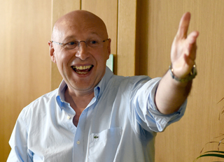 German winner of the Nobel Prize for chemistry Stefan Hell gestures at a small party with his colleagues in Goettingen, Germany, Wednesday, Oct. 8, 2014. Hell shares the prize with Americans Eric Betzig and William E. Moerner for developing ways to dramatically improve the resolution of optical microscopes. Hell developed the underlying technology for R&D 100 Awards-winning super-resolution microscopes from Leica. (Credit AP/dpa, Swen Pfoertner)