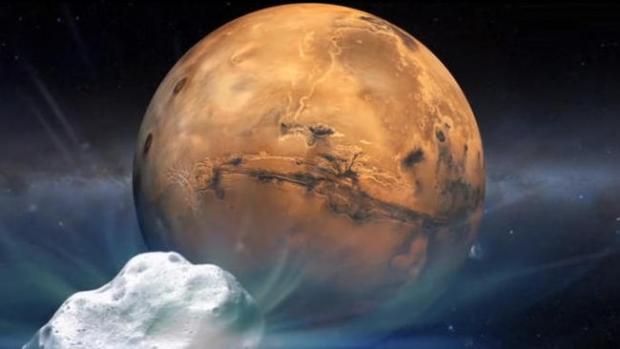 An artist's concept shows comet Siding Spring (C/2013 A1) heading toward Mars. (Credit: NASA)