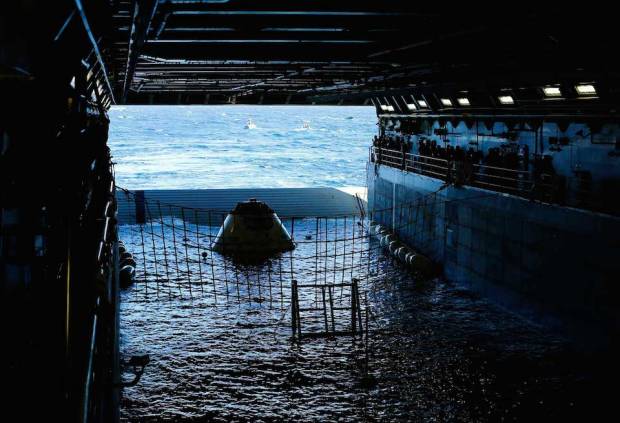 A test version of NASA's Orion capsule floats in the rear of the USS Anchorage during a recovery drill off the coast of California September 15, 2014. Orion is NASA's next exploration spacecraft, designed to carry astronauts to destinations in deep space, including an asteroid and Mars. Picture taken September 15, 2014.  (Credit: REUTERS/Mike Blake)