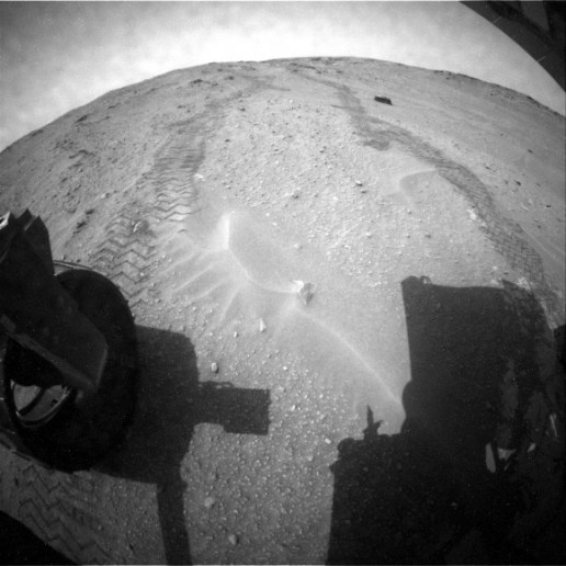 After a couple of years of racing towards Mount Sharp (Aeolis Mons), now it’s time for the Curiosity rover to get a better look at its Martian surroundings. Rover tracks and Martian sand as seen from the rear hazcam of NASA’s Curiosity rover. (Credit: NASA/JPL-Caltech)