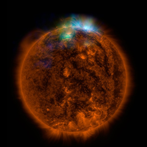 X-rays stream off the sun in this image showing observations from by NASA's Nuclear Spectroscopic Telescope Array, or NuSTAR, overlaid on a picture taken by NASA's Solar Dynamics Observatory (SDO).This image shows that some of the hotter emission tracked by NuSTAR is coming from different locations in the active regions and the coronal loops than the cooler emission shown in the SDO image.  (Credit: NASA/JPL-Caltech )