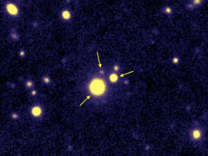  A false-color image from the W. M. Keck Observatory in Hawaii shows the first observed triple quasar—a trio of enormous, hyperactive black holes in close proximity to each other. The three quasars are 10.5 billion light-years away from Earth, meaning that the light being recorded is actually a glimpse into the early universe. (Credit: S. G. Djorgovski et al., Caltech, EPFL )